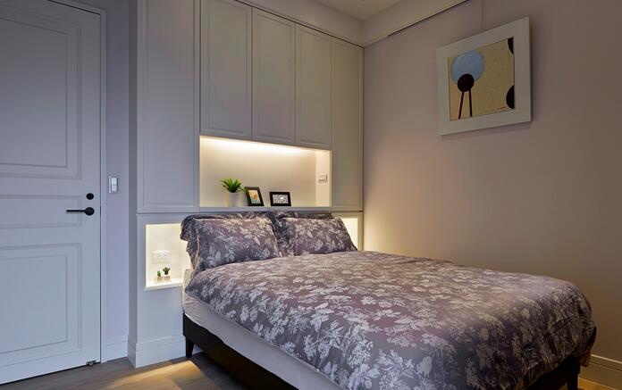 简单的空间，净白的床头，搭以柔和的灯光，营造令人舒适的睡卧环境。