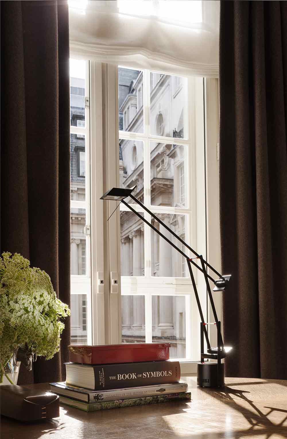 格子造型窗户前，茶褐色的窗帘体现着高雅的生活品味。造型简洁时尚的灯具充满个性。