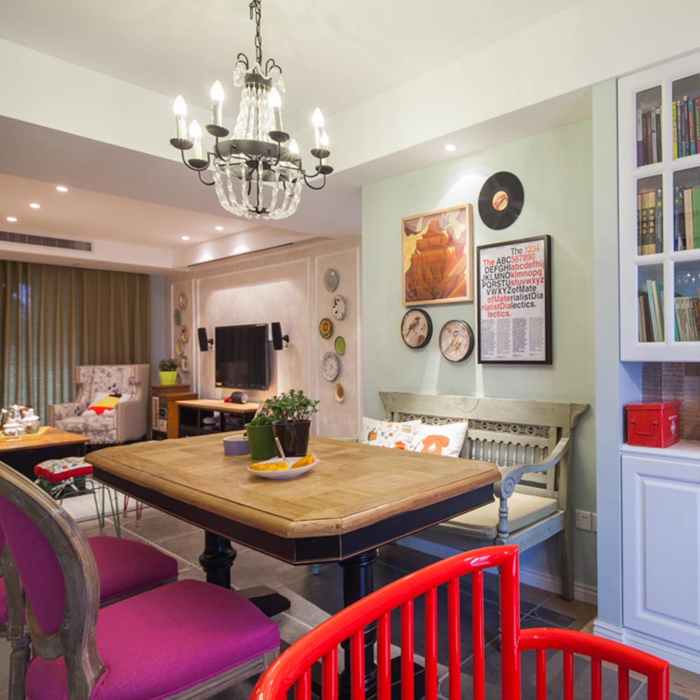 餐厅和客厅连在一起，同样大胆采用各种鲜艳色，红色和紫色的椅子特别出挑。