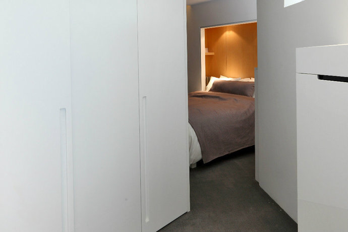落地式的衣柜兼作空间通道，顺便也提升了卧室的私密度，提升了安全感，三重利用妙趣横生。