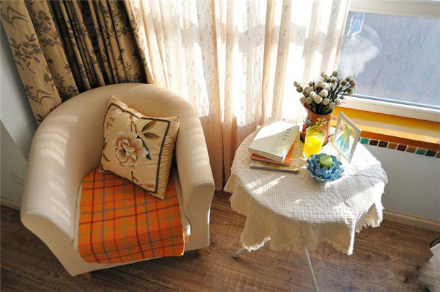沙发椅上的抱枕与窗帘的花纹很相似。