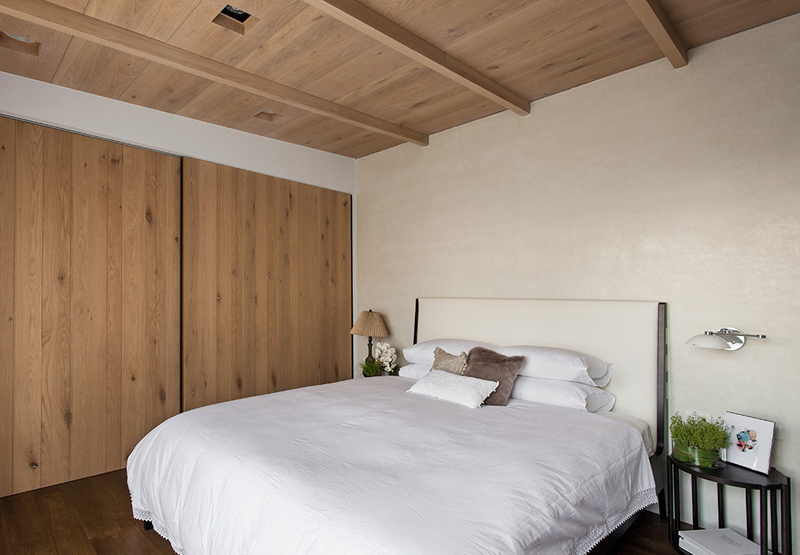 主卧的基调是朴实，不管是原木的吊顶隔墙，还是白色的大床，都带着简明的颜色和线条。