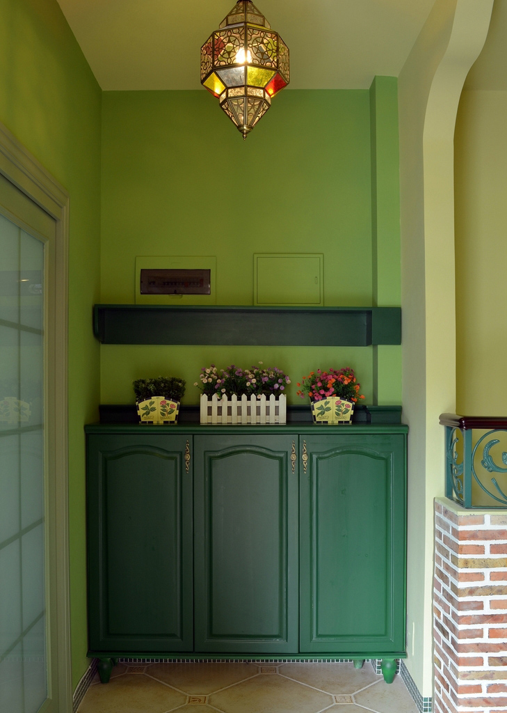 玄关处绿色的深浅配合，将小空间内的气氛用琉璃灯点燃，而几朵小花则各自芬芳。