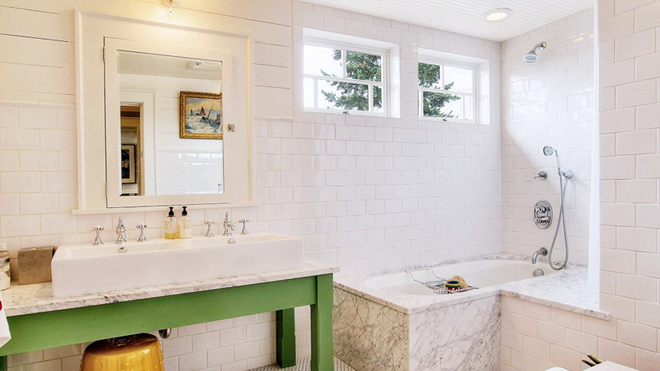 白色的墙砖可以让卫生间看起来更为整洁，草绿色的洗手台与整体设计相呼应，十分自然。