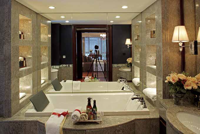 浴缸旁的正面镜子双倍放大了卫生间的空间。