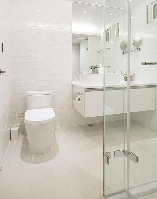 光滑的瓷砖具有极佳的反射效果，将卫浴空间内的明亮感大大提升。悬挂式的浴室柜则使区域内更具通透感。