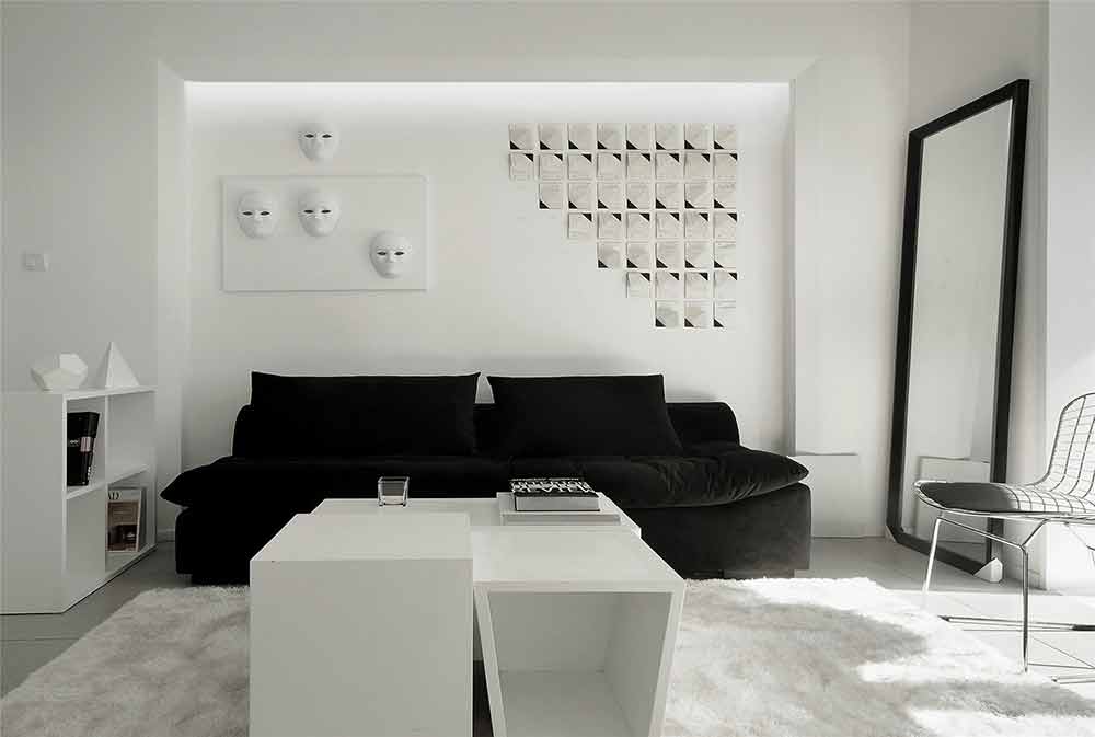 简单的黑色沙发搭配时尚个性的背景墙，精心挑选的几何设计的白色茶几，让这个空间简洁却不失单调。