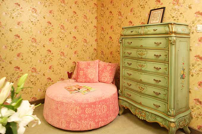 田园碎花的墙纸浪漫唯美，精致的收纳柜和粉色的休闲沙发不小心就透露出女主人满满的少女心。